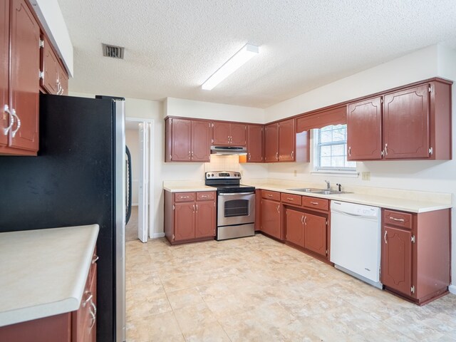 5210 N Northridge Rd, Valdosta, GA 31605 - kitchen featuring light countertops, stainless steel appliances, under cabinet range hood, a sink, and visible vents