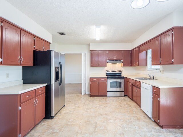 5210 N Northridge Rd, Valdosta, GA 31605 - kitchen featuring light countertops, visible vents, stainless steel appliances, under cabinet range hood, and a sink