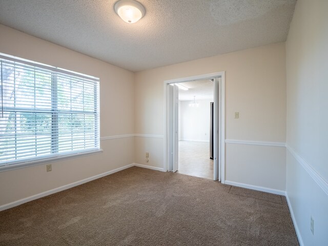 5210 N Northridge Rd, Valdosta, GA 31605 - spare room with baseboards, carpet flooring, and a textured ceiling