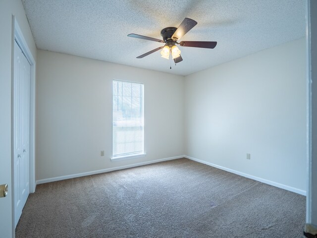 5210 N Northridge Rd, Valdosta, GA 31605 - unfurnished bedroom with carpet floors, baseboards, a closet, and a textured ceiling