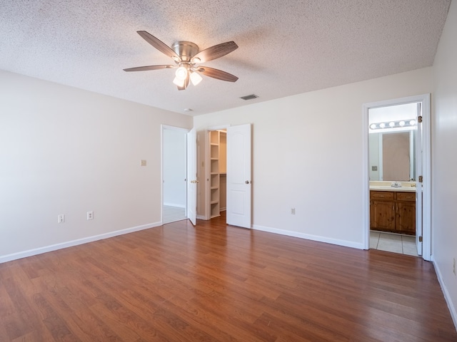 5210 N Northridge Rd, Valdosta, GA 31605 - unfurnished bedroom with visible vents, a spacious closet, and wood finished floors