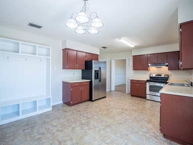 5210 N Northridge Rd, Valdosta, GA 31605 - kitchen with light countertops, a sink, under cabinet range hood, stainless steel appliances, and an inviting chandelier