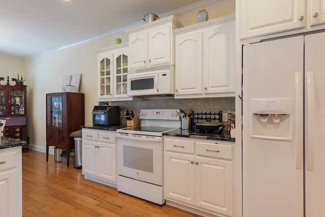 4311 Mossy Creek Rd, Valdosta, GA 31602 - kitchen featuring white appliances, backsplash, glass insert cabinets, crown molding, and white cabinetry