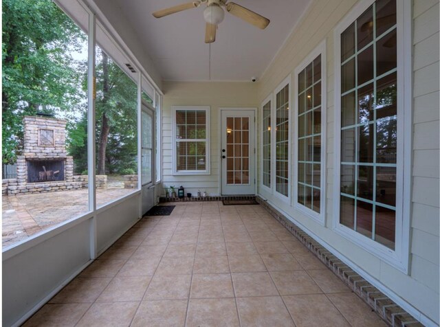 4311 Mossy Creek Rd, Valdosta, GA 31602 - unfurnished sunroom with ceiling fan and an outdoor stone fireplace
