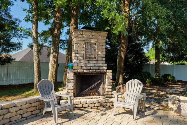 4311 Mossy Creek Rd, Valdosta, GA 31602 - view of patio / terrace featuring an outdoor stone fireplace and fence