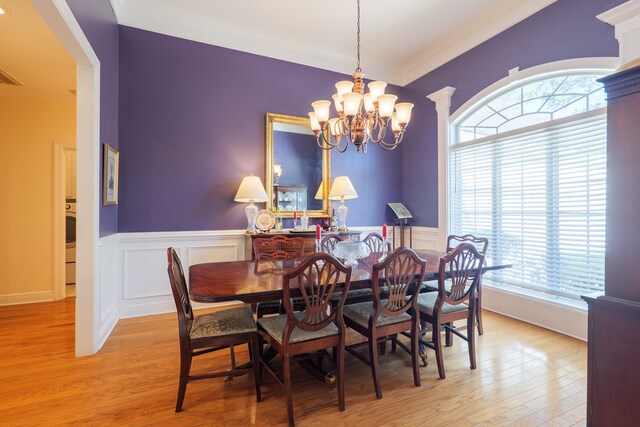 4311 Mossy Creek Rd, Valdosta, GA 31602 - dining area with a chandelier, wood finished floors, crown molding, healthy amount of natural light, and wainscoting