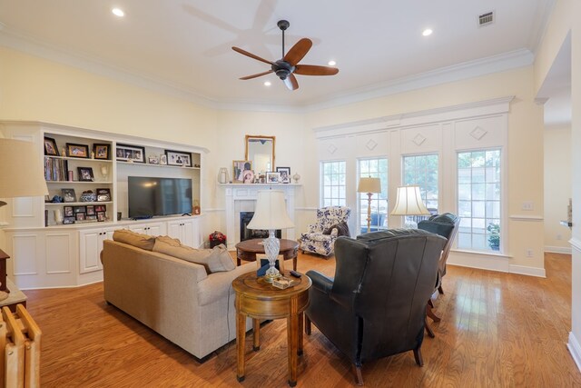 4311 Mossy Creek Rd, Valdosta, GA 31602 - living room with a fireplace, ceiling fan, light wood-style floors, recessed lighting, and crown molding