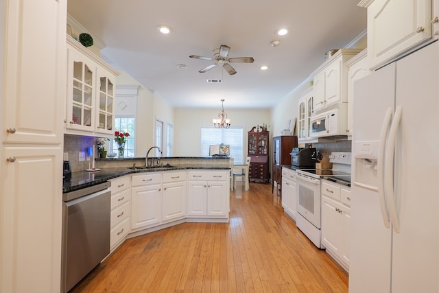 4311 Mossy Creek Rd, Valdosta, GA 31602 - kitchen with white appliances, a sink, a peninsula, ceiling fan, and a chandelier