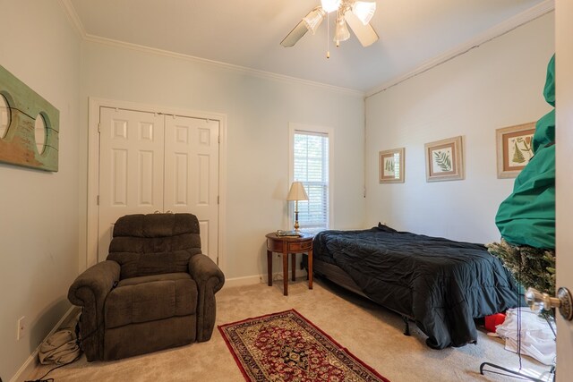 4311 Mossy Creek Rd, Valdosta, GA 31602 - bedroom with ornamental molding, light colored carpet, a closet, ceiling fan, and baseboards