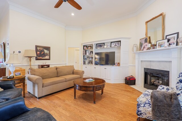 4311 Mossy Creek Rd, Valdosta, GA 31602 - living area with ornamental molding, a ceiling fan, light wood-style floors, a tiled fireplace, and recessed lighting
