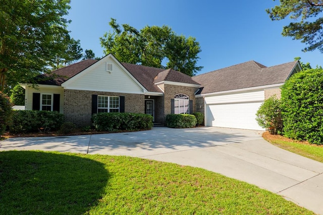 4311 Mossy Creek Rd, Valdosta, GA 31602 - view of front facade with concrete driveway, a front yard, an attached garage, and brick siding