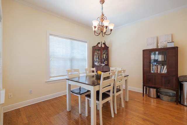 4311 Mossy Creek Rd, Valdosta, GA 31602 - dining room with a chandelier, ornamental molding, light wood-type flooring, and baseboards