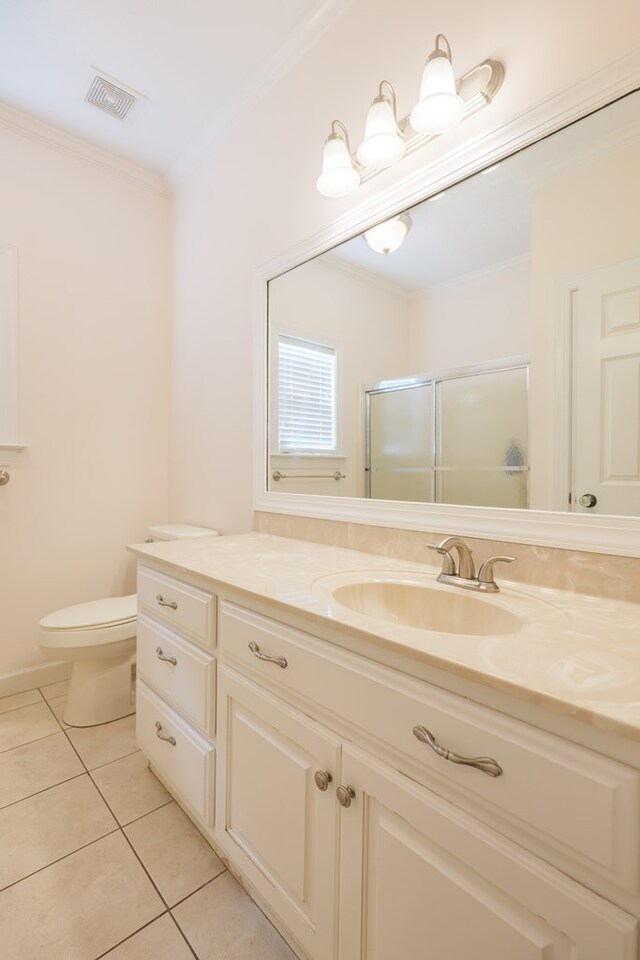 4311 Mossy Creek Rd, Valdosta, GA 31602 - full bath with tile patterned floors, a shower stall, crown molding, toilet, and vanity