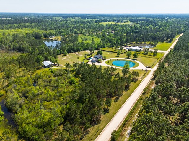 birds eye view of property with a forest view and a water view