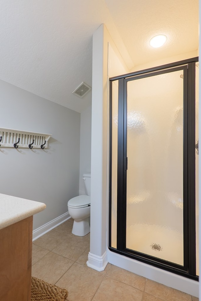 full bath with a shower stall, baseboards, tile patterned flooring, and visible vents