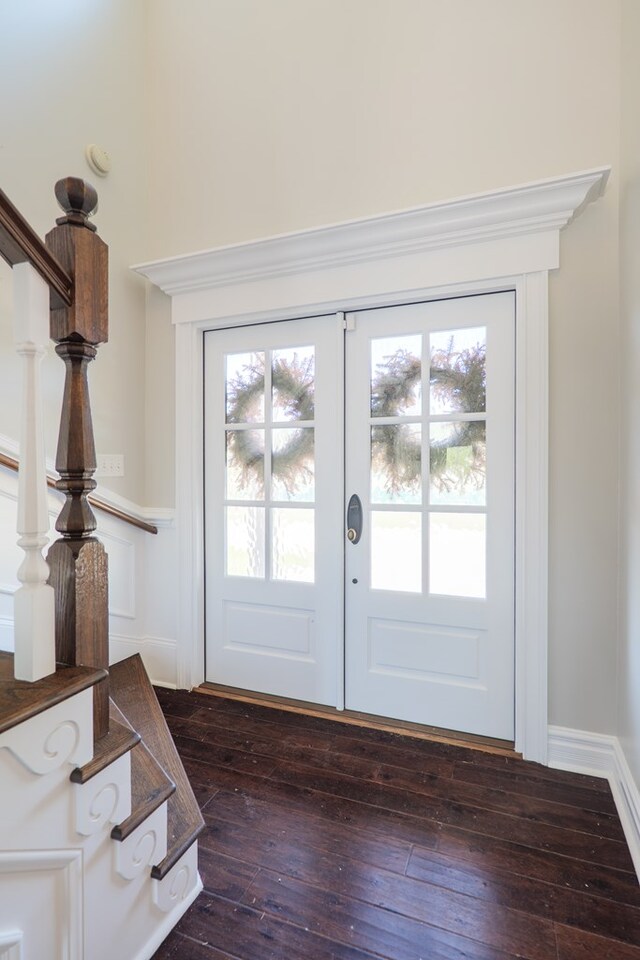 doorway with dark wood-type flooring, stairs, and french doors
