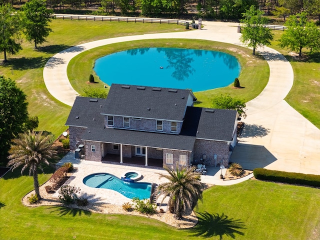 view of pool with fence, a patio area, and a lawn