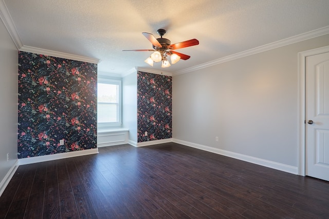 unfurnished room featuring dark wood finished floors, a ceiling fan, baseboards, and ornamental molding