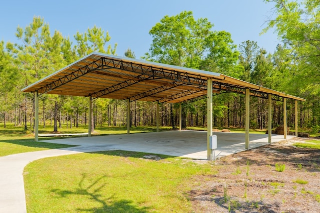 view of community with a detached carport and a yard