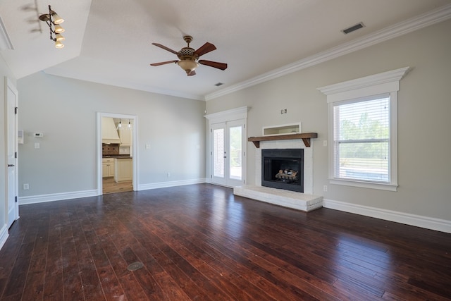 unfurnished living room featuring hardwood / wood-style floors, visible vents, a ceiling fan, baseboards, and a fireplace