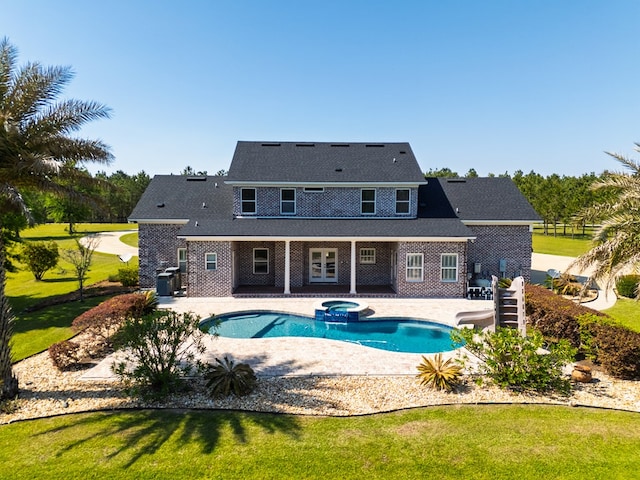view of pool featuring central AC, a patio area, a yard, a water slide, and a pool with connected hot tub