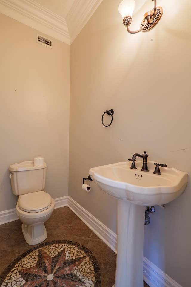 half bath featuring visible vents, toilet, baseboards, and ornamental molding
