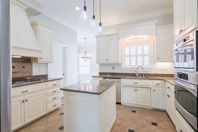 kitchen featuring stainless steel appliances, backsplash, a sink, pendant lighting, and custom exhaust hood