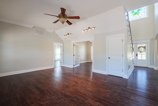 unfurnished living room with dark wood finished floors, baseboards, visible vents, lofted ceiling, and a ceiling fan