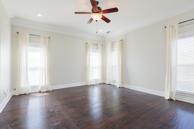 empty room featuring plenty of natural light, dark wood-style floors, ceiling fan, and crown molding
