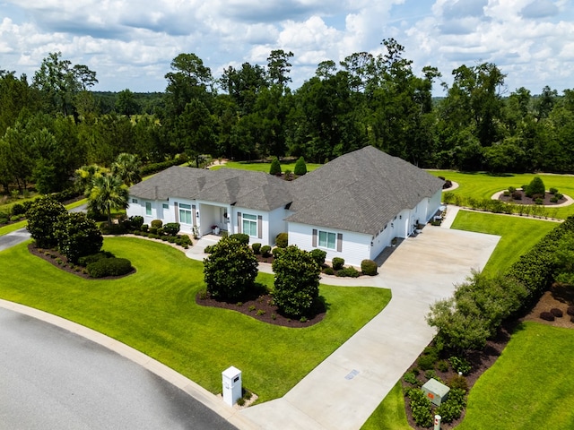 3870 Timber Ridge Rd, Valdosta, GA 31601 - view of front facade with concrete driveway, an attached garage, a front yard, and a shingled roof