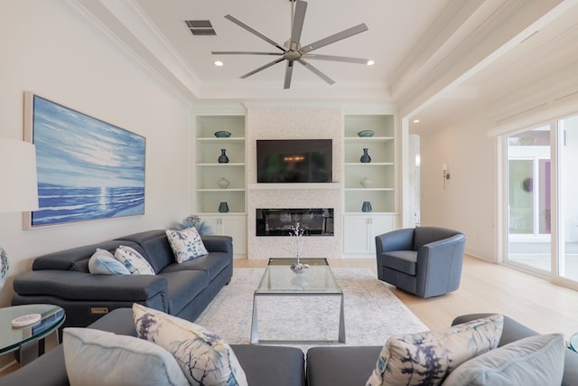 3870 Timber Ridge Rd, Valdosta, GA 31601 - living area featuring ornamental molding, a ceiling fan, light wood-type flooring, built in features, and a fireplace