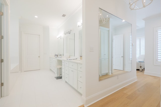 3870 Timber Ridge Rd, Valdosta, GA 31601 - full bath with double vanity, ornamental molding, a garden tub, a chandelier, and recessed lighting