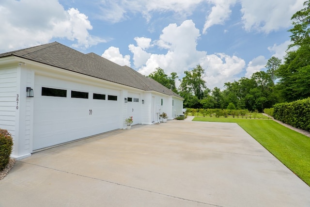 3870 Timber Ridge Rd, Valdosta, GA 31601 - view of side of property featuring a garage, concrete driveway, a lawn, and roof with shingles