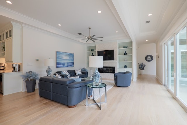 3870 Timber Ridge Rd, Valdosta, GA 31601 - living room featuring crown molding, light wood-style floors, a ceiling fan, a large fireplace, and recessed lighting