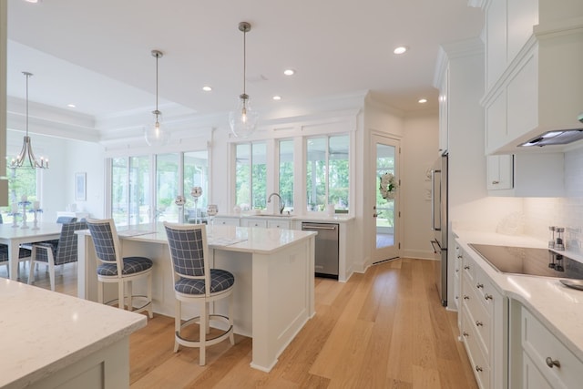 3870 Timber Ridge Rd, Valdosta, GA 31601 - kitchen featuring stainless steel appliances, white cabinets, light wood-style floors, crown molding, and decorative backsplash