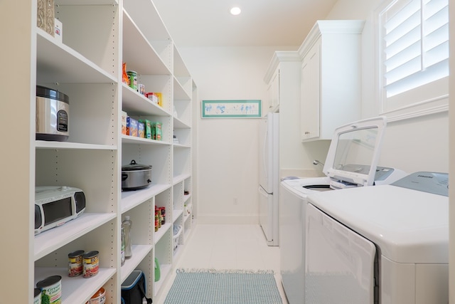 3870 Timber Ridge Rd, Valdosta, GA 31601 - laundry room with washer and clothes dryer, light tile patterned floors, and cabinet space