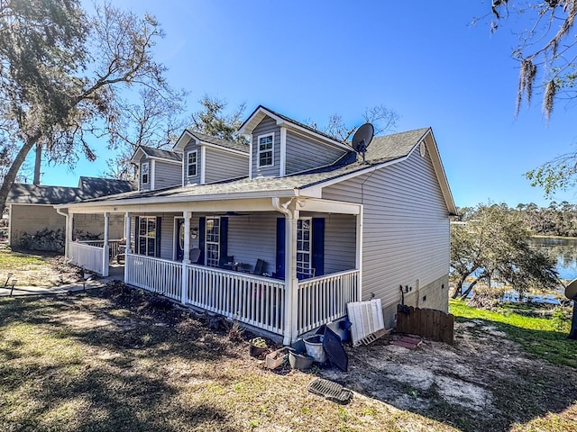 view of side of home featuring covered porch