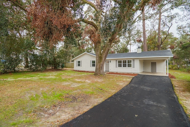 ranch-style house with a front lawn and a carport