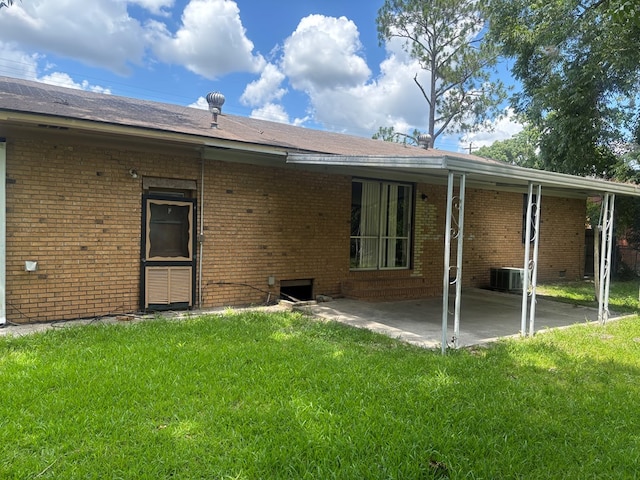 1511 E Moore St, Valdosta, GA 31601 - rear view of house with a patio area, a yard, and brick siding