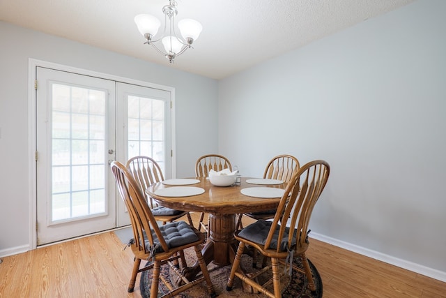 dining space featuring a chandelier, a wealth of natural light, and light wood-style floors