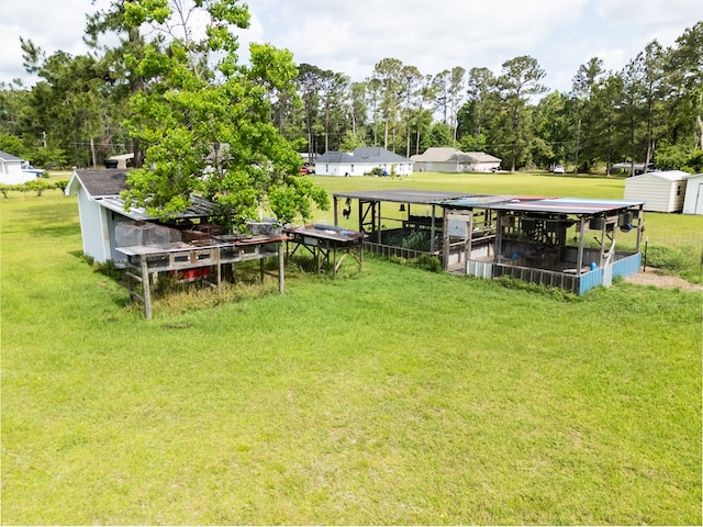 view of yard featuring a storage shed and an outbuilding