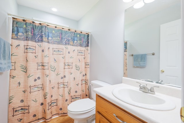 full bathroom with toilet, curtained shower, and vanity