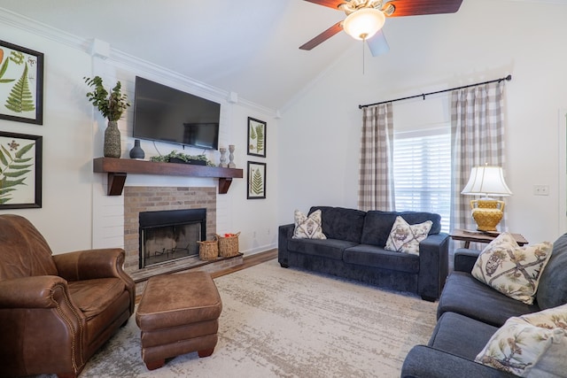 living room with lofted ceiling, ornamental molding, a fireplace, wood finished floors, and a ceiling fan