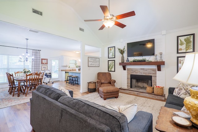 living area featuring visible vents, wood finished floors, and ornamental molding