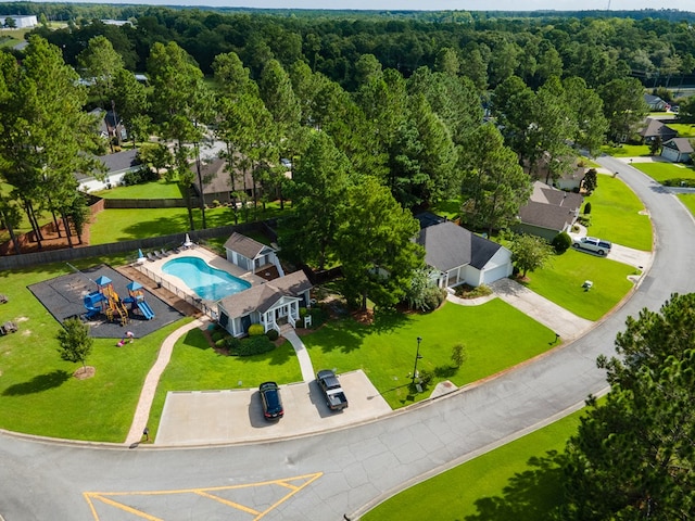 birds eye view of property with a view of trees