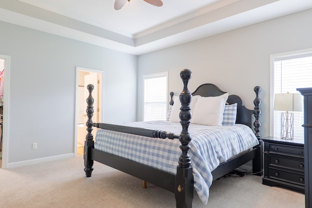 bedroom with crown molding, multiple windows, light colored carpet, and baseboards