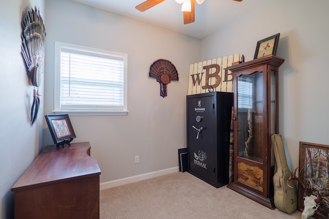 interior space featuring ceiling fan, baseboards, and carpet