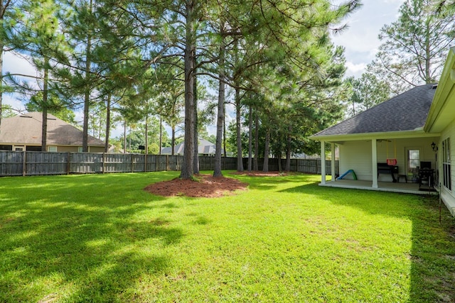 view of yard featuring a patio and a fenced backyard