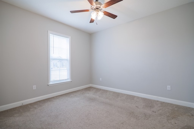 spare room featuring ceiling fan and carpet flooring