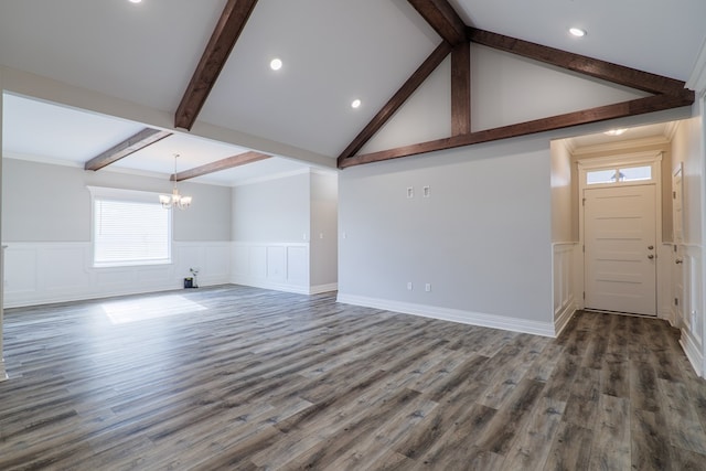 unfurnished living room with ornamental molding, dark hardwood / wood-style floors, vaulted ceiling with beams, and a notable chandelier